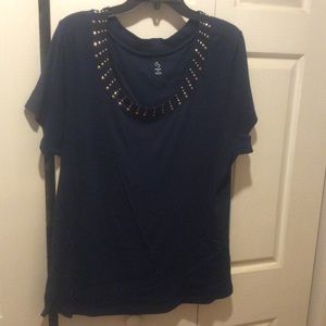 1X knit top with embellishments on neckline.